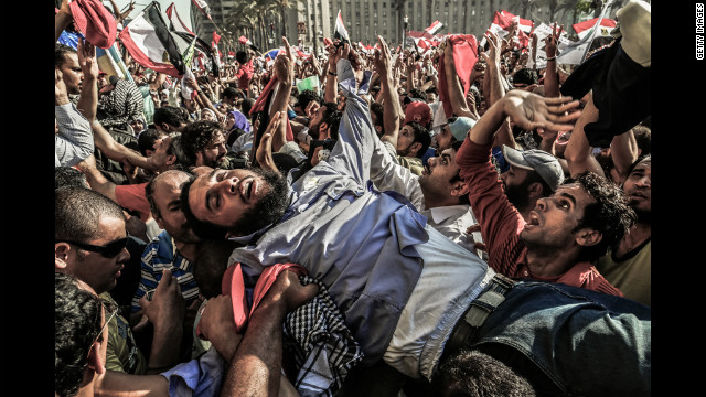 A supporter of the Muslim Brotherhood is carried away from the tightly packed arena of Tahrir Square in Cairo on Sunday as Mohamed Morsi supporters celebrate his victory in Egypt's presidential election.
