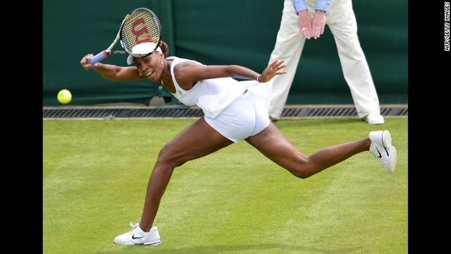 Venus Williams plays a shot during her first-round match against Russia's Elena Vesnina on June 25. Williams lost the match, her earliest exit from the tournament in 15 years.