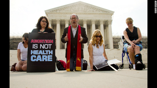 The Rev. Patrick Mahoney leads demonstrators in prayer outside the Supreme Court on Monday, June 25, as they await the court's ruling. 