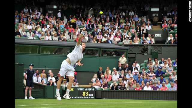 Britain's Andy Murray serves during his first-round singles victory over Russia's Nikolay Davydenko on June 26.