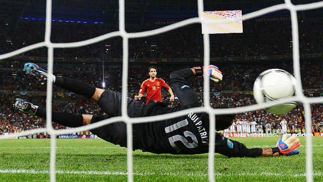 Spain's Cesc Fabregas scores the decisive penalty past Portugal's Rui Patricio in Donetsk