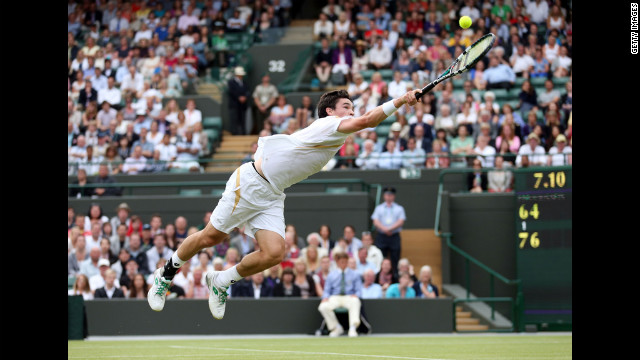Jamie Baker of Great Britain dives for a backhand return during his first-round match against Andy Roddick of the United States on Wednesday, June 27, at Wimbledon.
