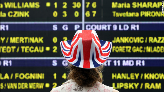 A fan studies the scoreboard at the Wimbledon championships at the All England Lawn Tennis Club in London June 28