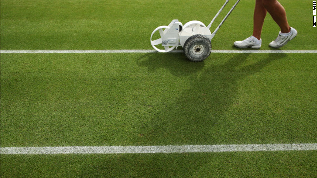 Fresh lines are painted on one of the courts at Wimbledon before the beginning of the match June 28.