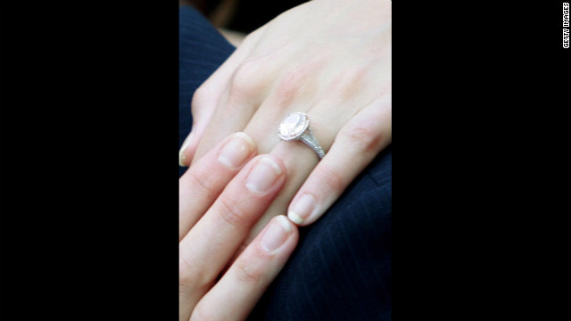 Holmes shows off her engagement ring as she arrives with Cruise at the UK premiere of "War Of The Worlds" at the Odeon Leicester Square in London in 2005.