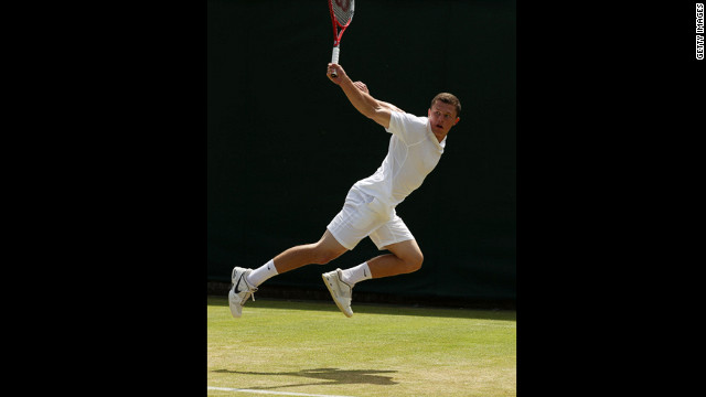 Clay Crawford of Great Britain glides through the air Saturday and returns a backhand to Yoshihito Nishioka of Japan.