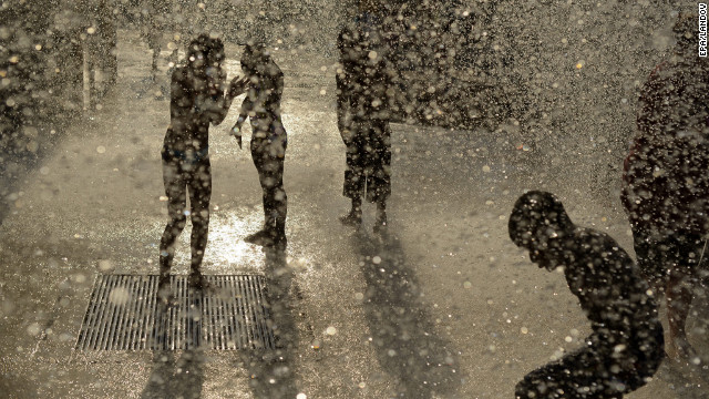 Children play in the water at Six Flags Over Georgia in Atlanta, where temperatures topped 100 degrees on Friday.