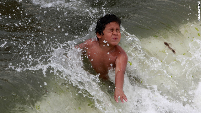 A boy plays in the ocean at Coney Island on Saturday.