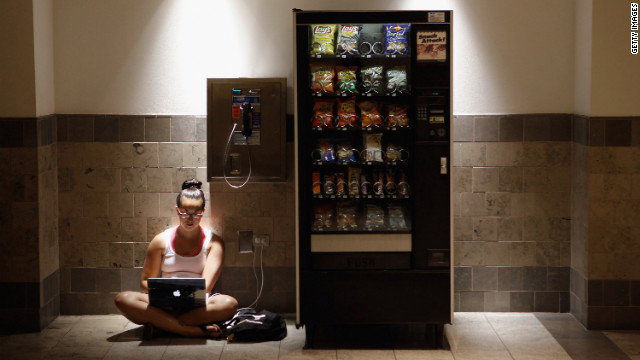 Katie Kiang finds shelter from the heat to study for the Graduate Record Examinations inside an air-conditioned mall in Silver Spring, Maryland, on Monday. Kiang's home is one of the thousands without electricity after storms hit hard.