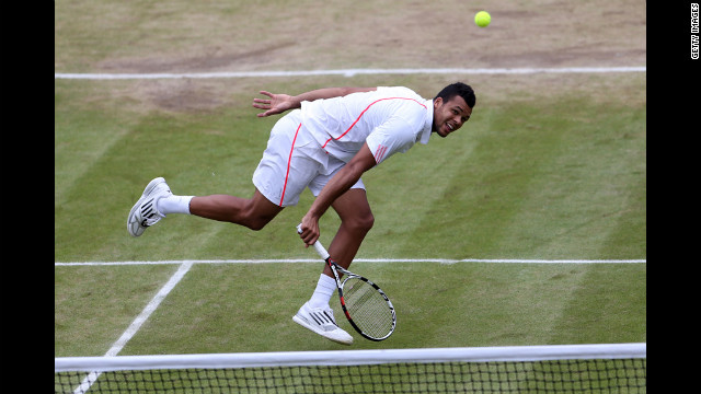 Jo-Wilfried Tsonga of France returns a shot during his Gentlemen's Singles fourth round match against American Mardy Fish.
