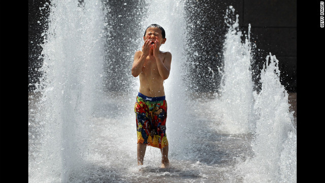 Six-year-old Spencer Hwang-Geddes of Ithaca, New York, cools off at the Yards Park on Thursday. Weather forecast predicted the hot weather will last through Sunday with possible daily triple-digit temperatures.