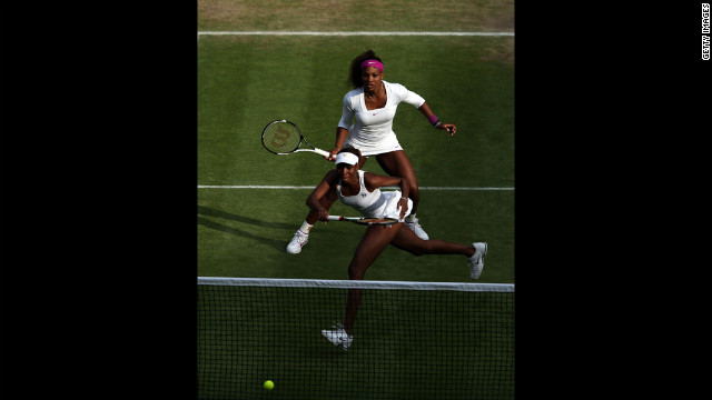 Serena Williams, top, and Venus Williams of the United States team up in their women's doubles quarter-final match against Raquel Kops-Jones and Abigail Spears of the United States on Thursday.