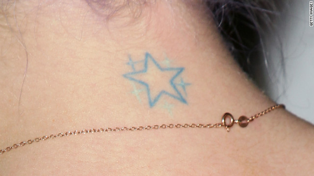 Kelly Osbourne, who has said she regrets getting some of her tattoos, shows a star on her neck.