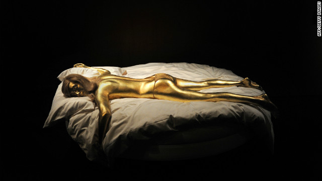 A replica of the character Jill Masterson, suffocated when she was painted with gold in "Goldfinger," is a centerpiece of the newly-opened James Bond exhibition in London.