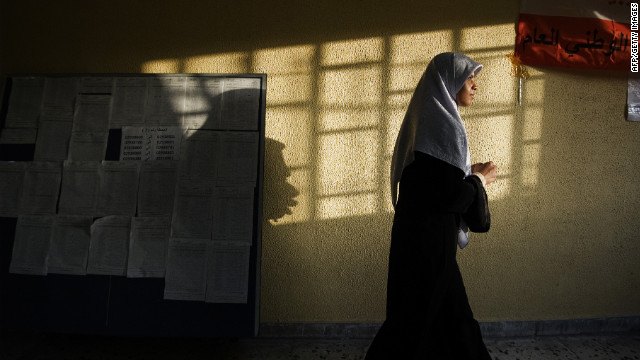 After casting her ballot, a Libyan woman leaves a polling station in Tripoli.