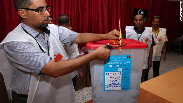 A Libyan election official opens a ballot box at a Tajura polling station.