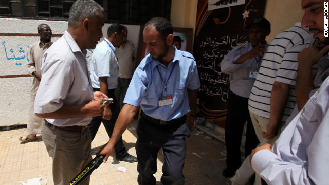 A voter goes through a security checkpoint outside a polling station in the Abu Slim neighbourhood of Tripoli.