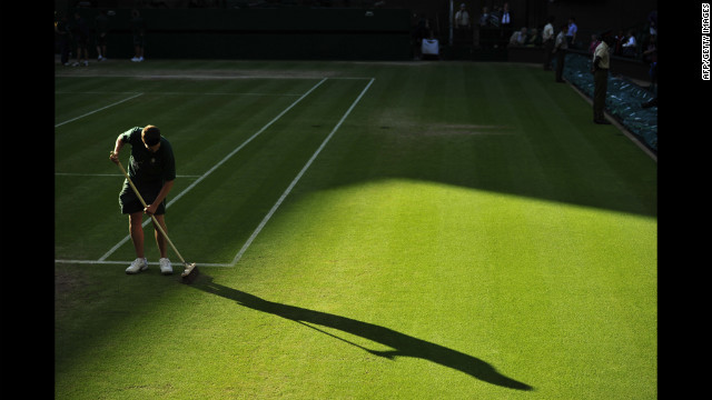 A groundskeeper prepares the grass on Centre Court on Friday.