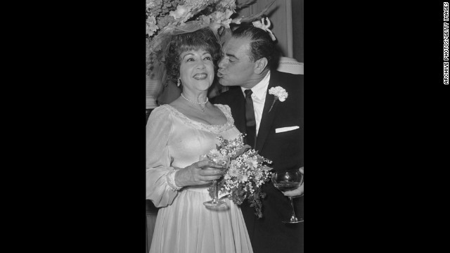 Borgnine leans in to kiss actress Ethel Merman during their 1964 wedding reception in Beverly Hills, California. They broke up in about a month and were officially divorced the next year.