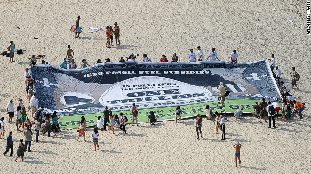 Activist unveil a banner on Copacabana beach to ask world leaders to end fossil fuel subsidies 