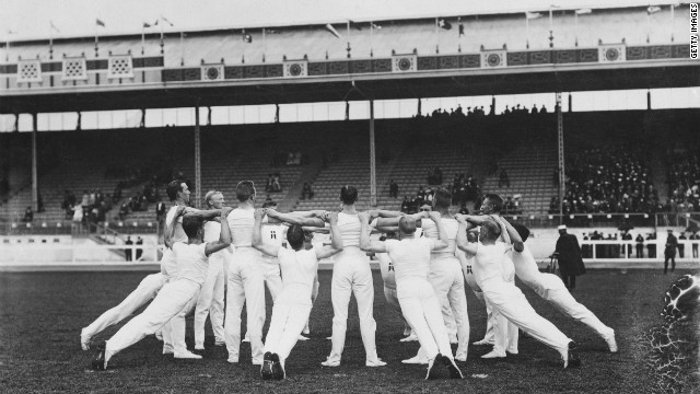 Danish gymnasts cut a stark contrast in their white finery against the backdrop of the arena, on July 14. 