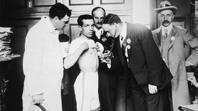 A marathon runner is examined by a doctor ahead of the event. However the check-up didn't appear to help Pietri, who fell down five times in the last 2km of the race. He was helped back up by umpires each time. 