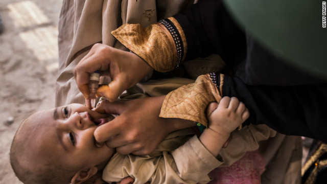 A three-month-old infant receives polio vaccination drops from his mother at a camp in Jalozai, Pakistan on July 13.