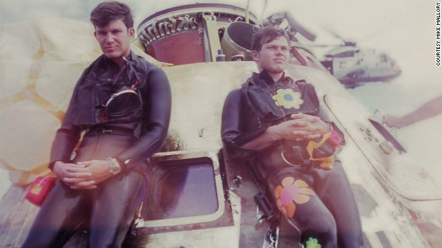 Navy SEALs Wes Chesser, left, and John Wolfram pause after securing the Apollo 11 capsule on July 24, 1969. Wolfram wore 60s "Flower Power" decals, showing his rebellious side. Chesser says, that only now does he realize how physically demanding the mission was. "We were in such good shape."