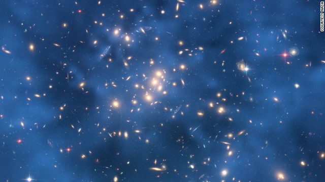 Science on the big scale and the small scale is important for understanding the structure of the universe. The Hubble Space Telescope is looking for indications of dark matter in star clusters, while particle experiments are also hunting down this mysterious substance. 
