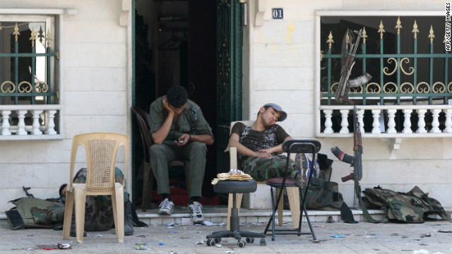 Members of Syria security forces rest in the al-Midan area in Damascus on Friday.