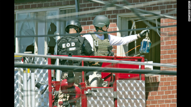 Officers prepare to place an explosive device inside the apartment.