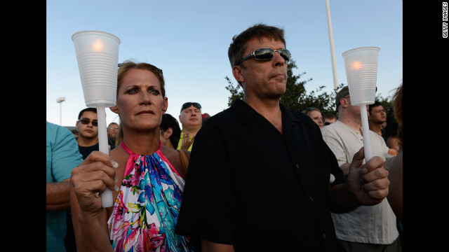 Alicia Prevette, left, and Paul Stepherson attend a vigil for the victims Friday at the Century 16 movie theater. 