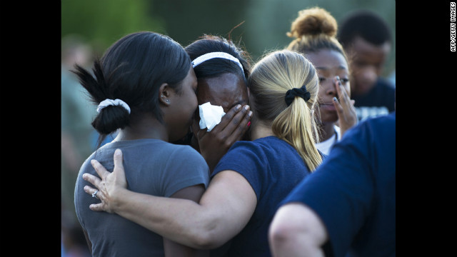 Mourners hug as they grieve the loss of the victims. 