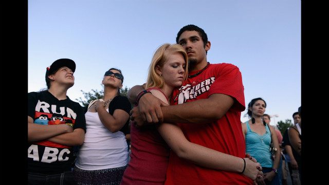 Lonnie Delgado, right, hugs Heaven Leek during a prayer.