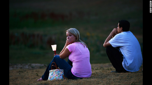 A woman looks at a makeshift memorial after attending a candlelight vigil.