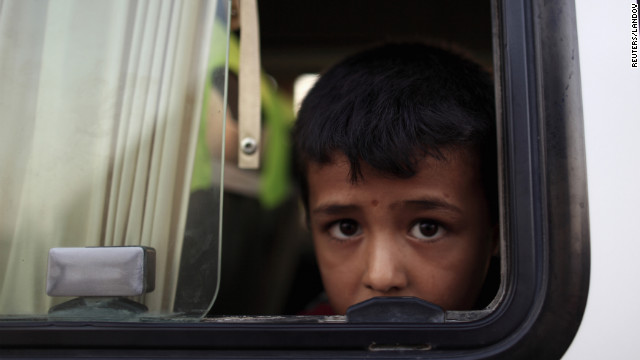 On Sunday, July 22, a Syrian refugee looks out from a bus as he arrives at a refugee camp in Turkey, which is opposite of the Syrian commercial crossing point Bab al-Hawa.