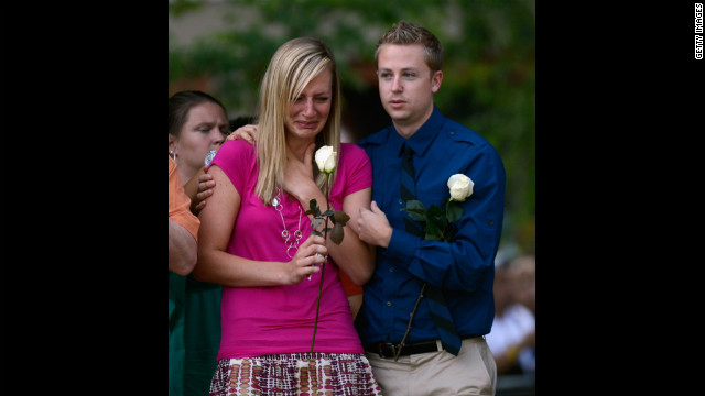 A woman is overcome with emotion during the vigil.