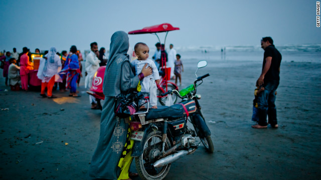  A woman holds her son as people celebrate Pakistan's Independence Day on August 14, 2011, in Karachi.