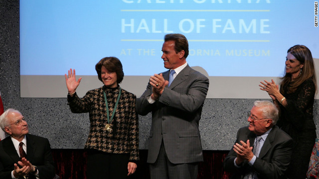 California Gov. Arnold Schwarzenegger applauds Ride after inducting her into the California Hall of Fame on December 6, 2006, in Sacramento, California.