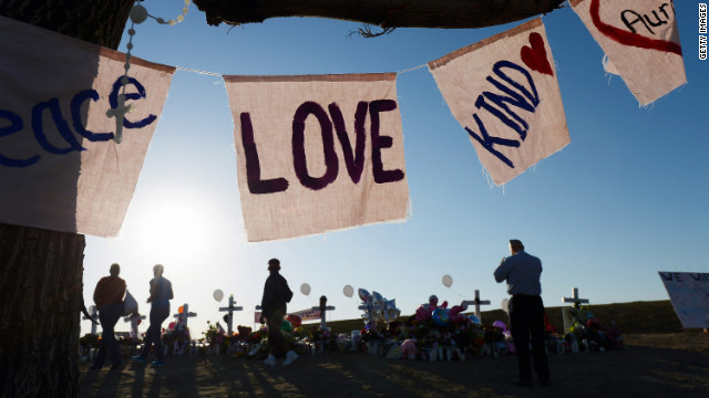 Visitors pay tribute Tuesday, July 24, at the makeshift memorial.