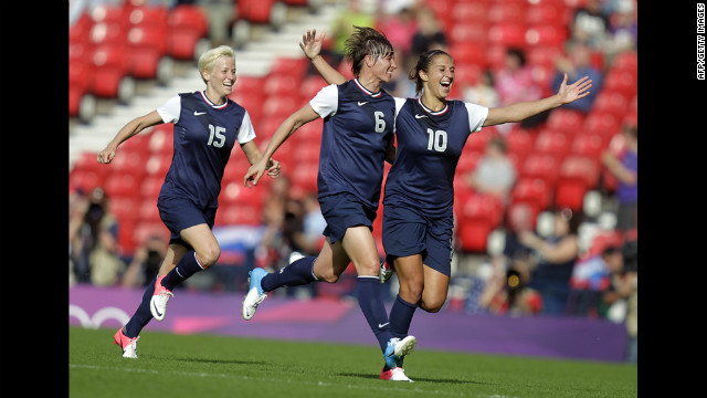 American Carli Lloyd celebrates with teammate Amy Le Peilbet after scoring her team's third goal.