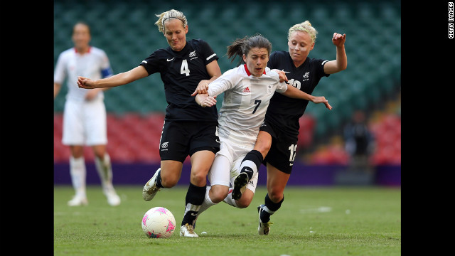 Katie Hoyle, left, of New Zealand and teammate Betsy Hassett challenge Karen Carney of Great Britain during their match in the first round of women's soccer in the London 2012 Olympic Games at Millennium Stadium on Wednesday, July 25, in Cardiff, Wales.