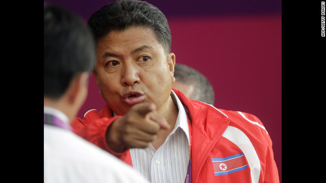 North Korean official Son Kwang-ho waits for the match against Colombia to begin.
