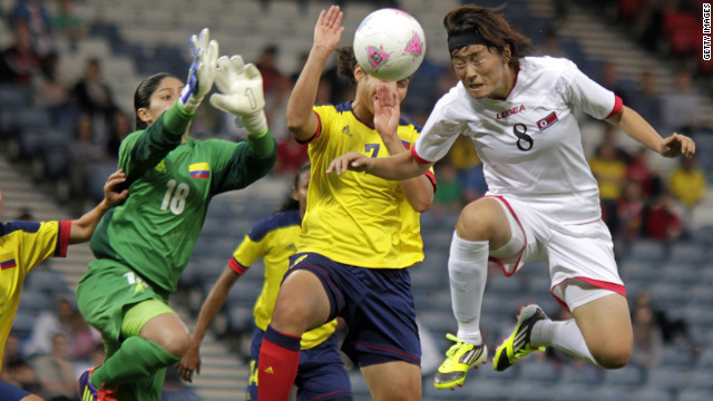 North Korea's Jon Myong Hwa, in white, vies with Colombia's Sandra Sepulveda, in green, and Orianica Velasquez , in yellow, during first-round women's soccer play at Hampden Park on July 25.