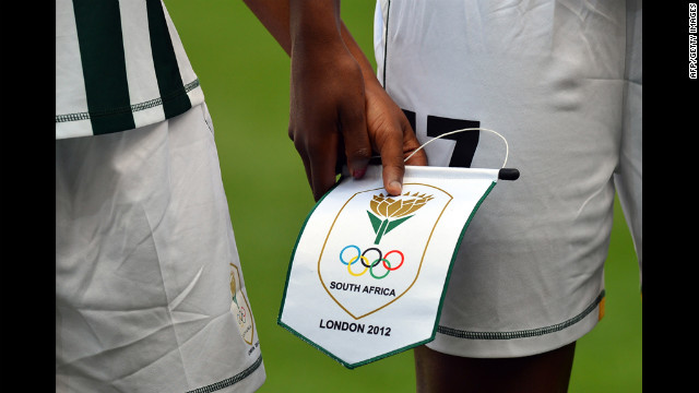 South African footballers hold a pennant as they line up before their first-round women's soccer match against Sweden on July 25 at The City of Coventry Stadium in Coventry, England.