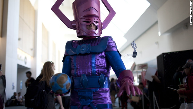 The ancient Galactus (complete with a puny, watchful Silver Surfer) brings along a planet as a Comic-Con snack.