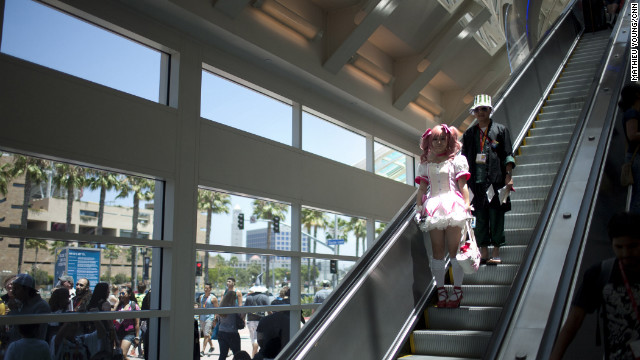 Madoka Kaname (from "Madoka Magica") and Kisuke Urahara (from "Bleach") exude a cool otaku vibe as they head to the ground floor of the San Diego Convention Center.