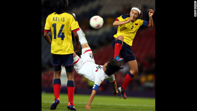Kim Song Hui of North Korea executes a bicycle kick while challenged by Natalia Ariza of Colombia during the first-round women's football competition at Hampden Park on Wednesday, July 25, in Glasgow, Scotland.