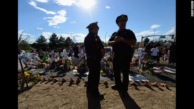 Kevin Flynn, left, Aurora Police top brass division chief, and Cmdr. Jack Daluz visit the makeshift memorial.