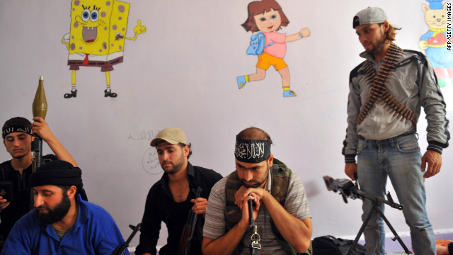 Fighters from the Syrian opposition rest at a former primary school in Aleppo on Wednesday.